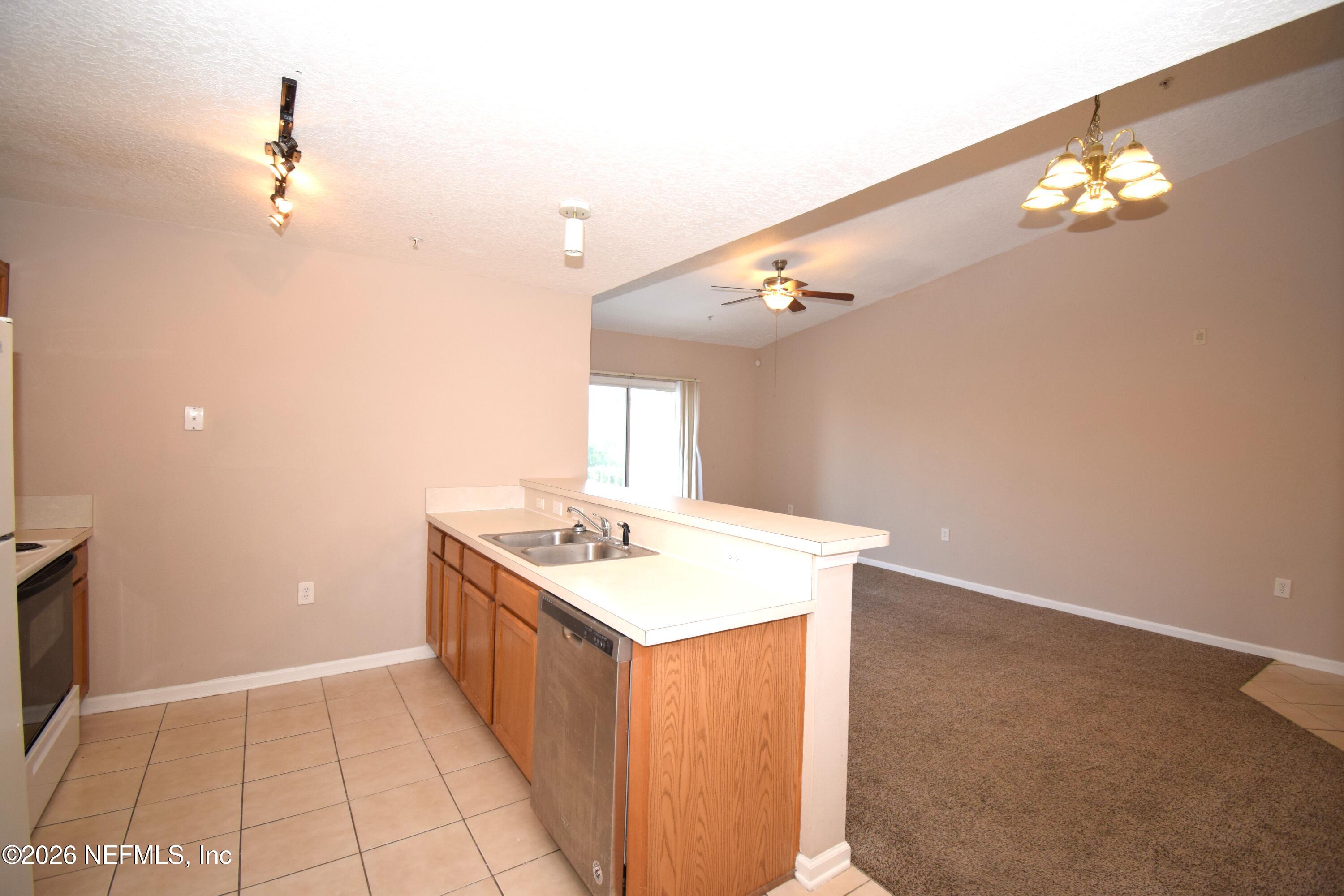 7920 Merrill Road, Unit 1811 Jacksonville, FL 32277 - Photo 7 of 15 a bathroom with a sink a vanity and a mirror