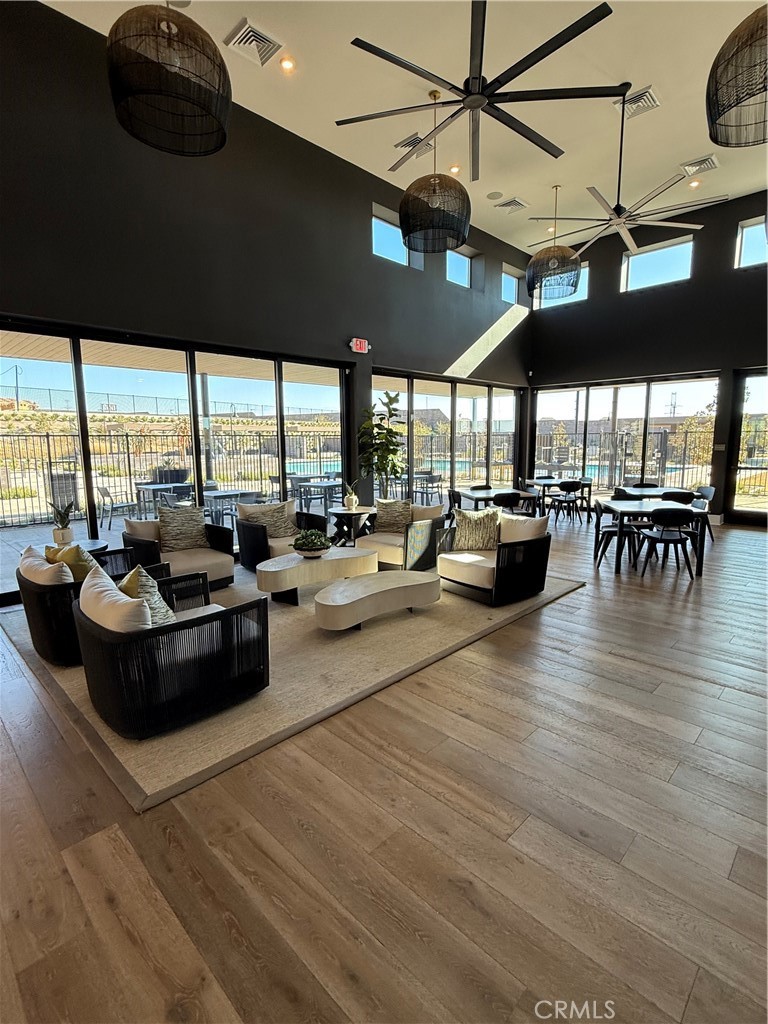 15844 Caterpillar Drive Fontana, CA 92336 - Photo 14 of 19 a living room with lots of furniture and floor to ceiling windows