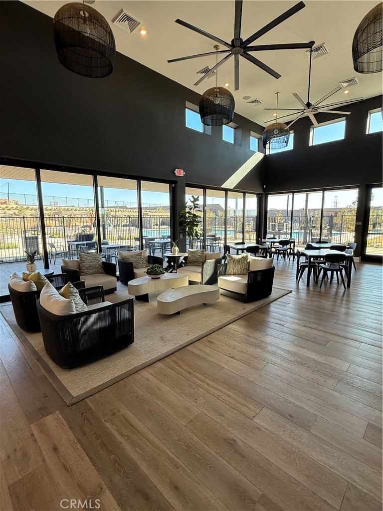 15844 Caterpillar Drive Fontana, CA 92336 - Photo 15 of 19 a living room with lots of furniture and floor to ceiling windows