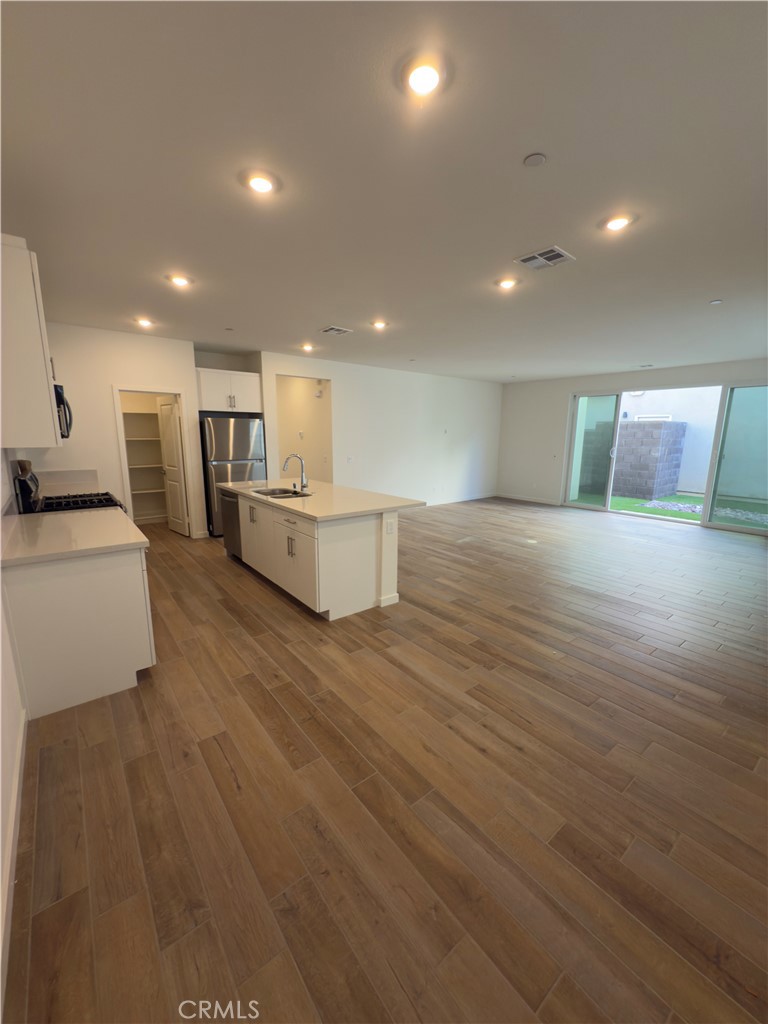 15844 Caterpillar Drive Fontana, CA 92336 - Photo 4 of 19 a large room with kitchen view