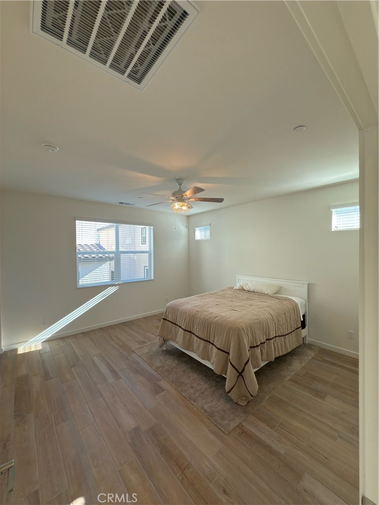 15844 Caterpillar Drive Fontana, CA 92336 - Photo 8 of 19 a spacious bedroom with a bed and a window