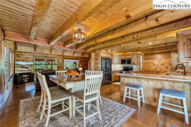 a view of a dining room with furniture wooden floor and a rug