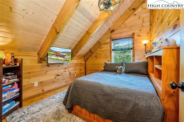 a bed sitting in a bedroom next to a window