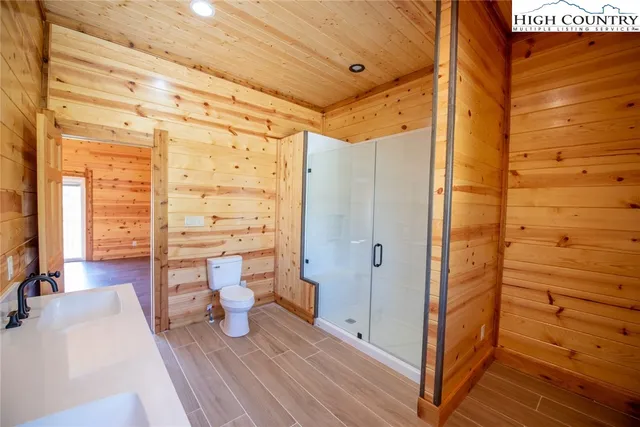 a bathroom with a toilet and a shower