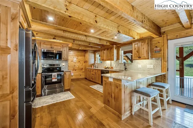 a kitchen with stainless steel appliances granite countertop a stove and cabinets