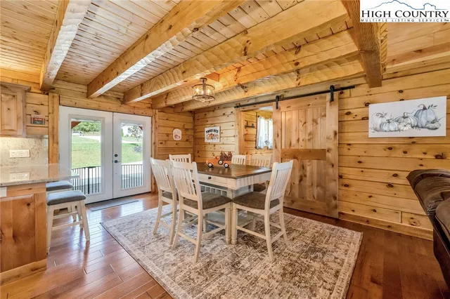 a dining room with furniture a rug and wooden floor