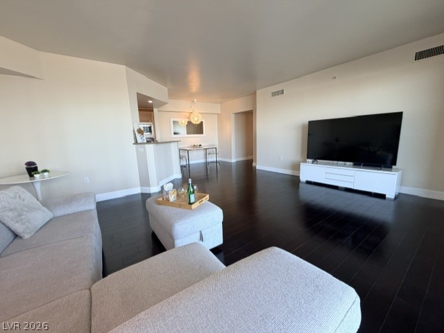 2777 Paradise Road, Unit 807 Las Vegas, NV 89109 - Photo 41 of 61 Rich hardwood flooring stretches across an inviting, open-concept living and dining area.