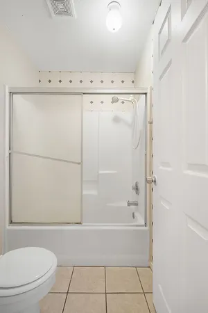 a bathroom with a bathtub a toilet and a shower