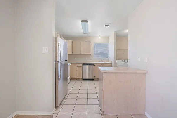 a kitchen with stainless steel appliances a refrigerator and a stove