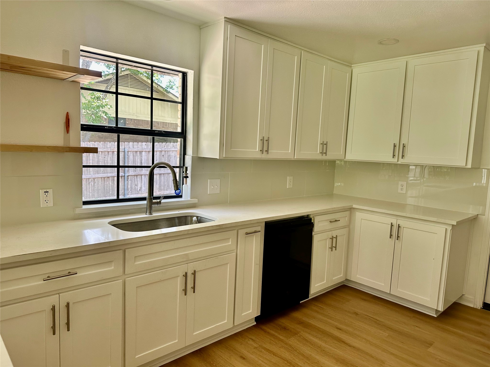 1612 Buttercup Road Pflugerville, TX 78660 - Photo 4 of 16 A well-lit kitchen features pristine white cabinetry and sleek countertops, ready for culinary endeavors.