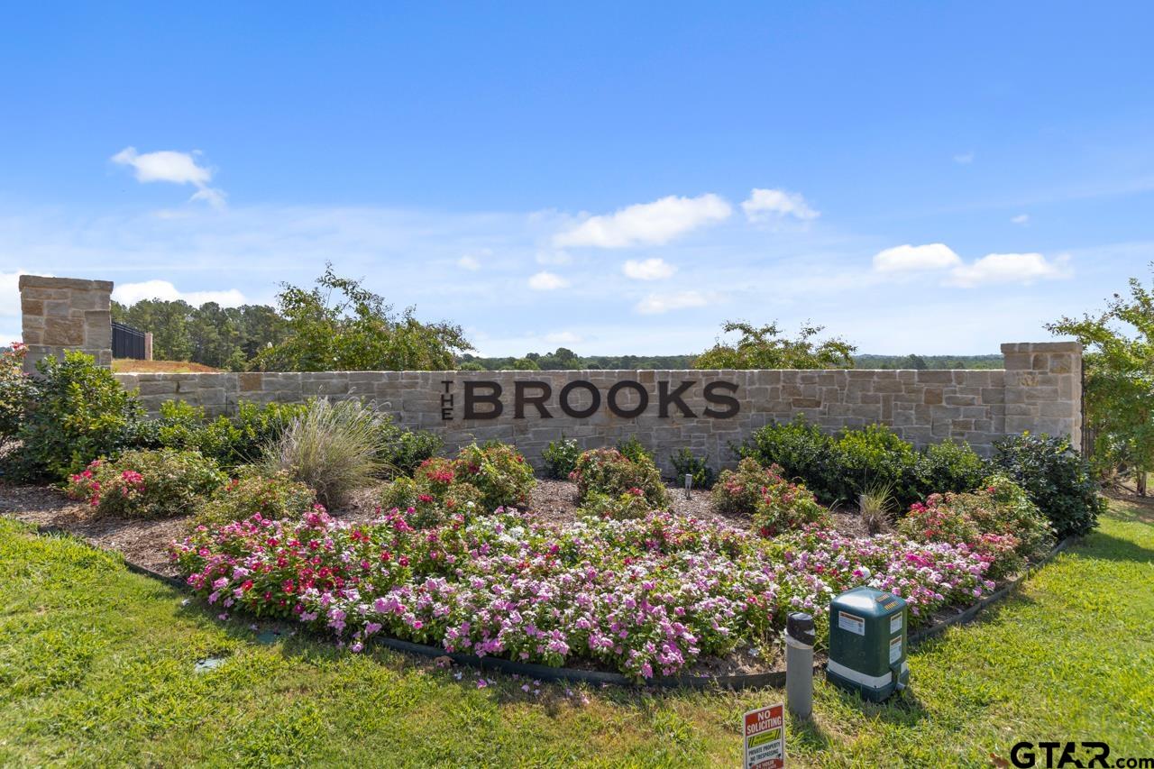 9154 Cave Br Cove Tyler, TX 75703 - Photo 1 of 2 a view of a garden with a lot of flower plants and wooden fence