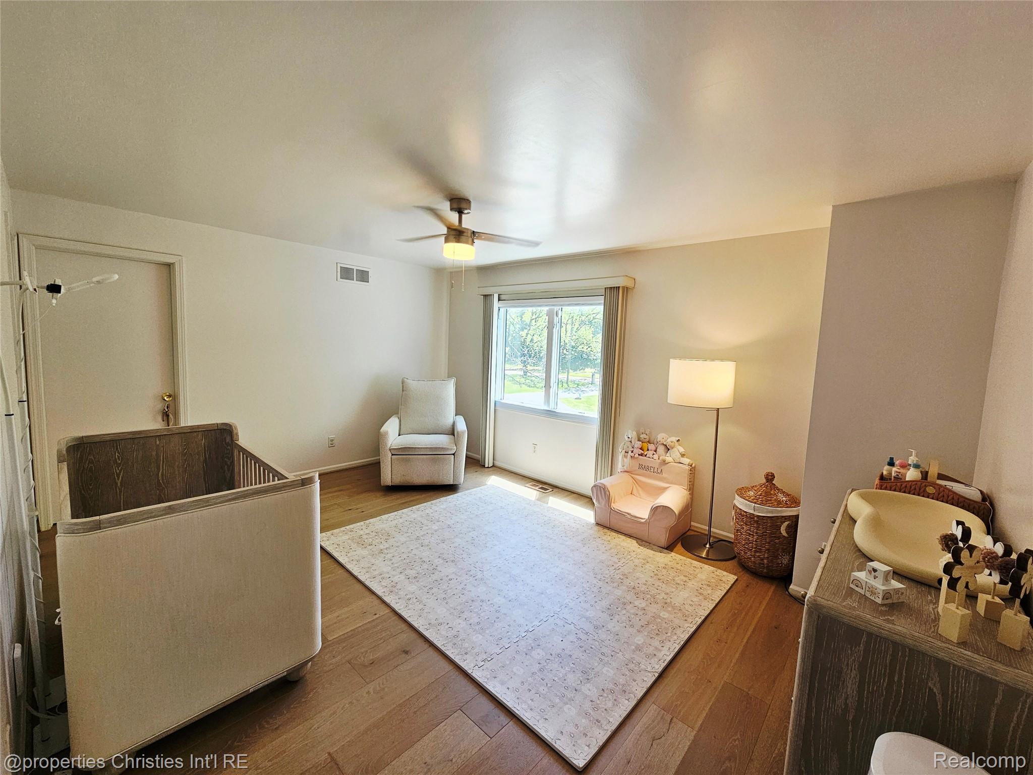 1830 Lone Pine Road Bloomfield Hills, MI 48302 - Photo 30 of 49 Spacious room featuring wood-finish flooring, a ceiling fan, and a large window