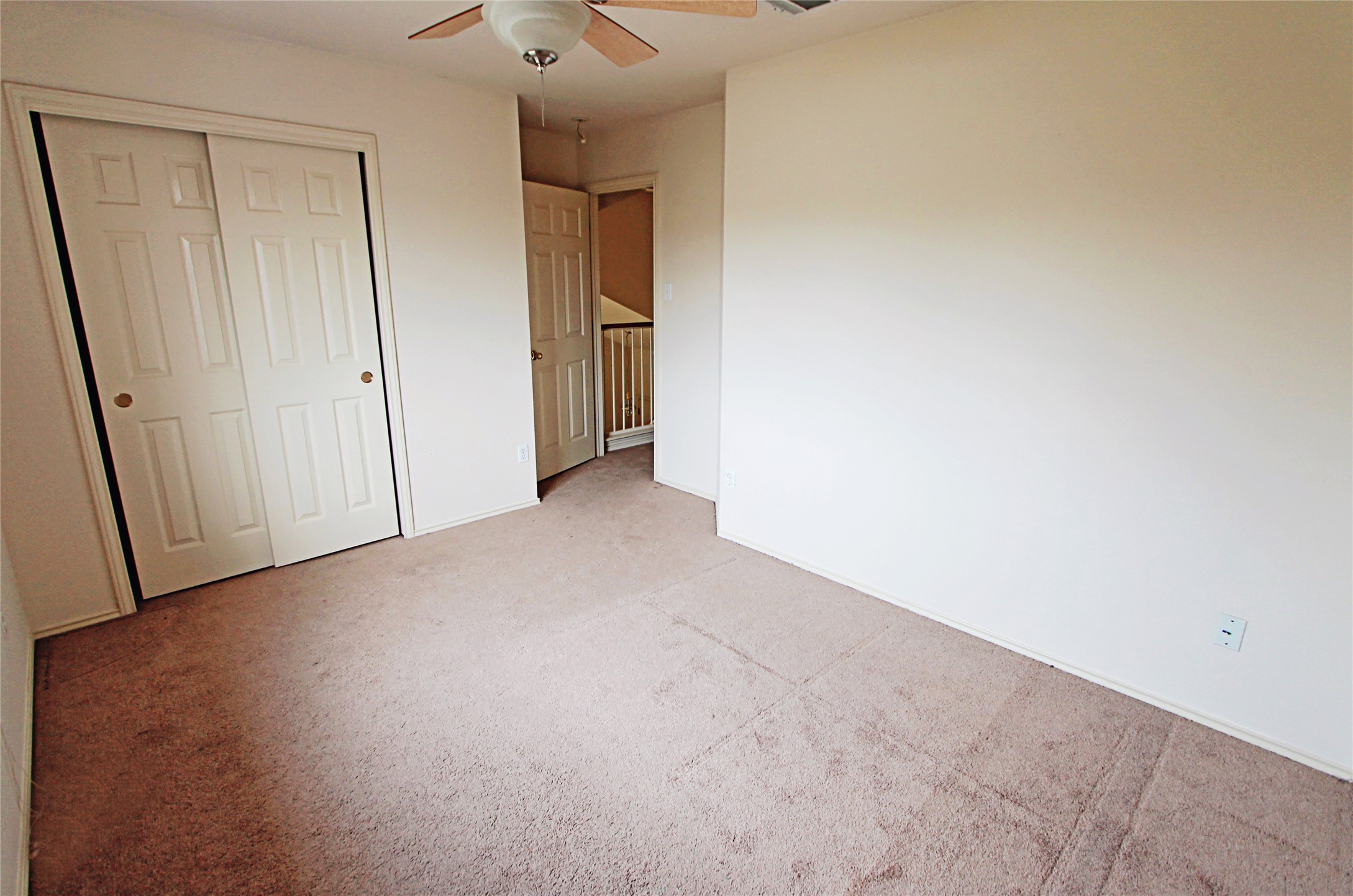 1821 Friars Tale Lane Austin, TX 78748 - Photo 17 of 20 Unfurnished bedroom with light carpet, a closet, and ceiling fan