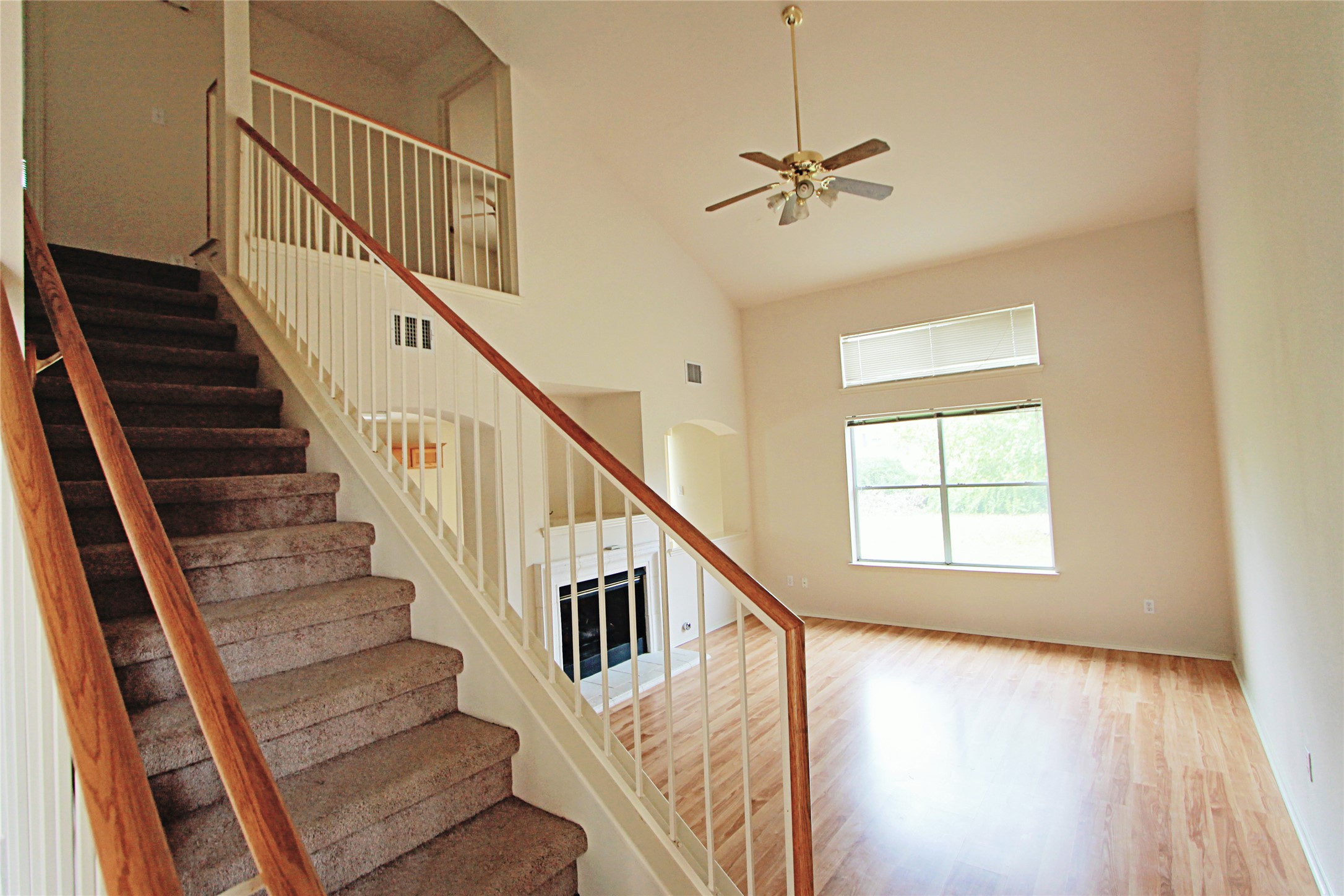 1821 Friars Tale Lane Austin, TX 78748 - Photo 3 of 20 Stairs featuring a high ceiling, a ceiling fan, wood finished floors, and arched walkways