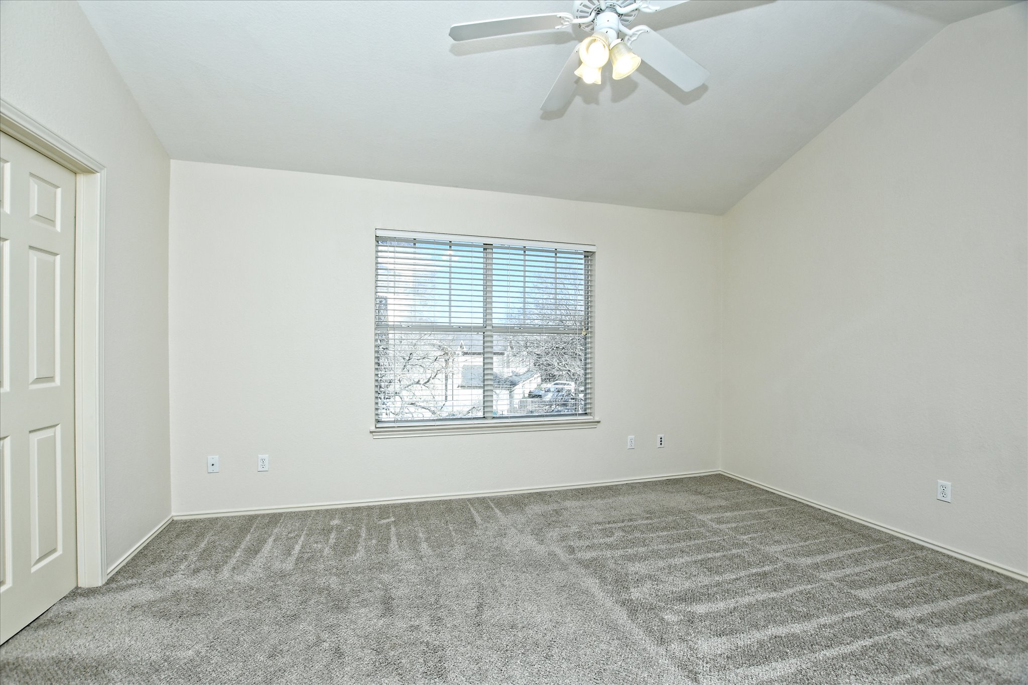 4400 Switch Willo, Unit 9 Austin, TX 78727 - Photo 13 of 30 Unfurnished bedroom featuring carpet flooring, ceiling fan, and vaulted ceiling