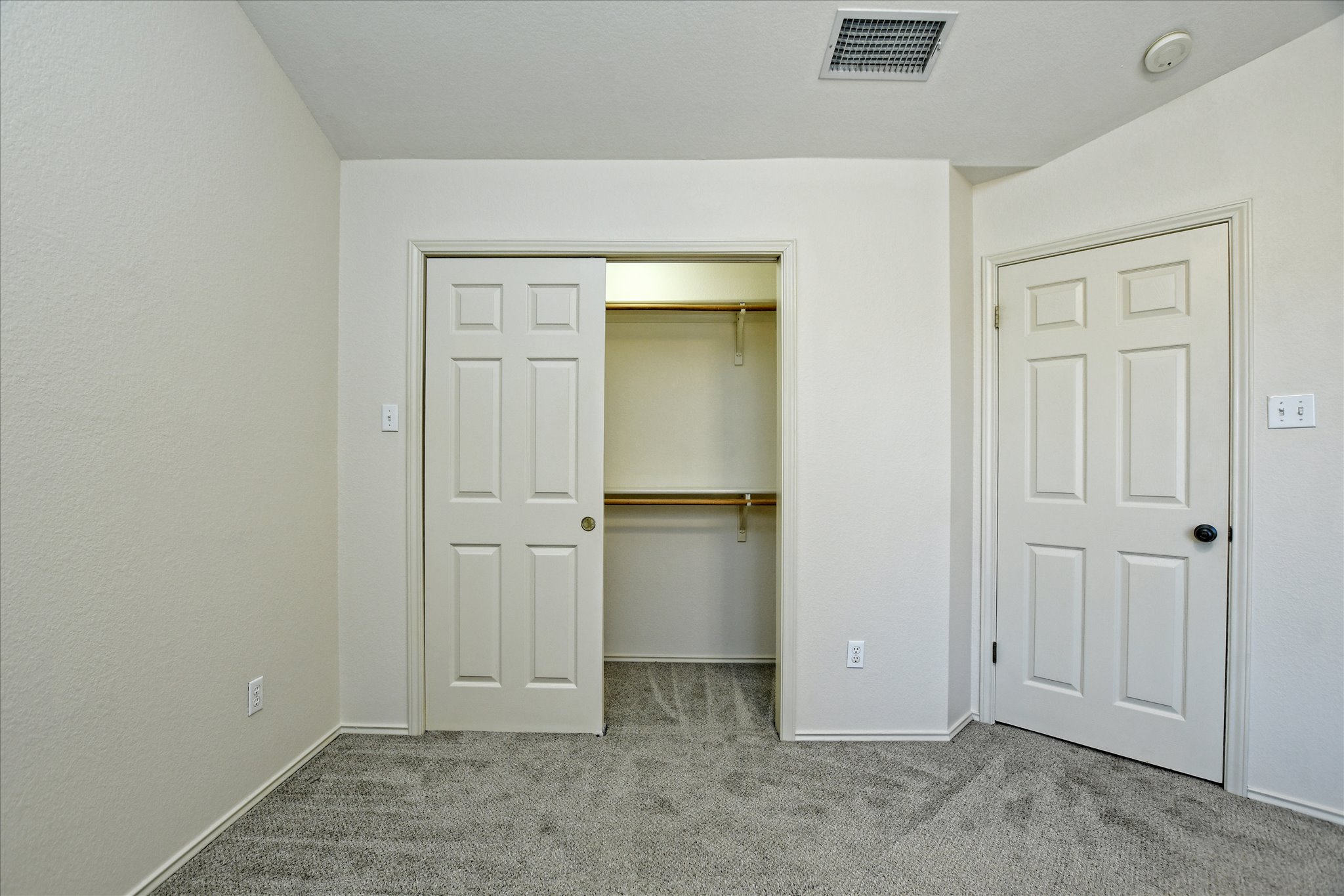 4400 Switch Willo, Unit 9 Austin, TX 78727 - Photo 14 of 30 Unfurnished bedroom featuring light colored carpet and a closet