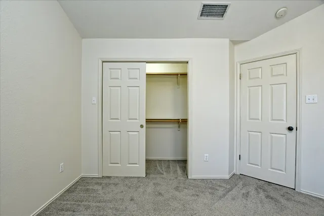 an empty room with closet area
