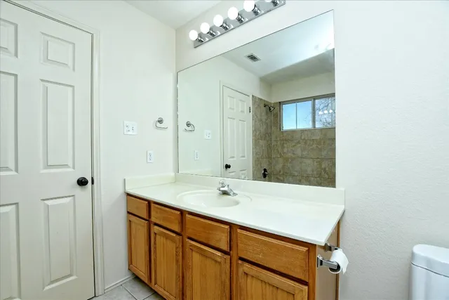 a bathroom with a sink a mirror and a shower