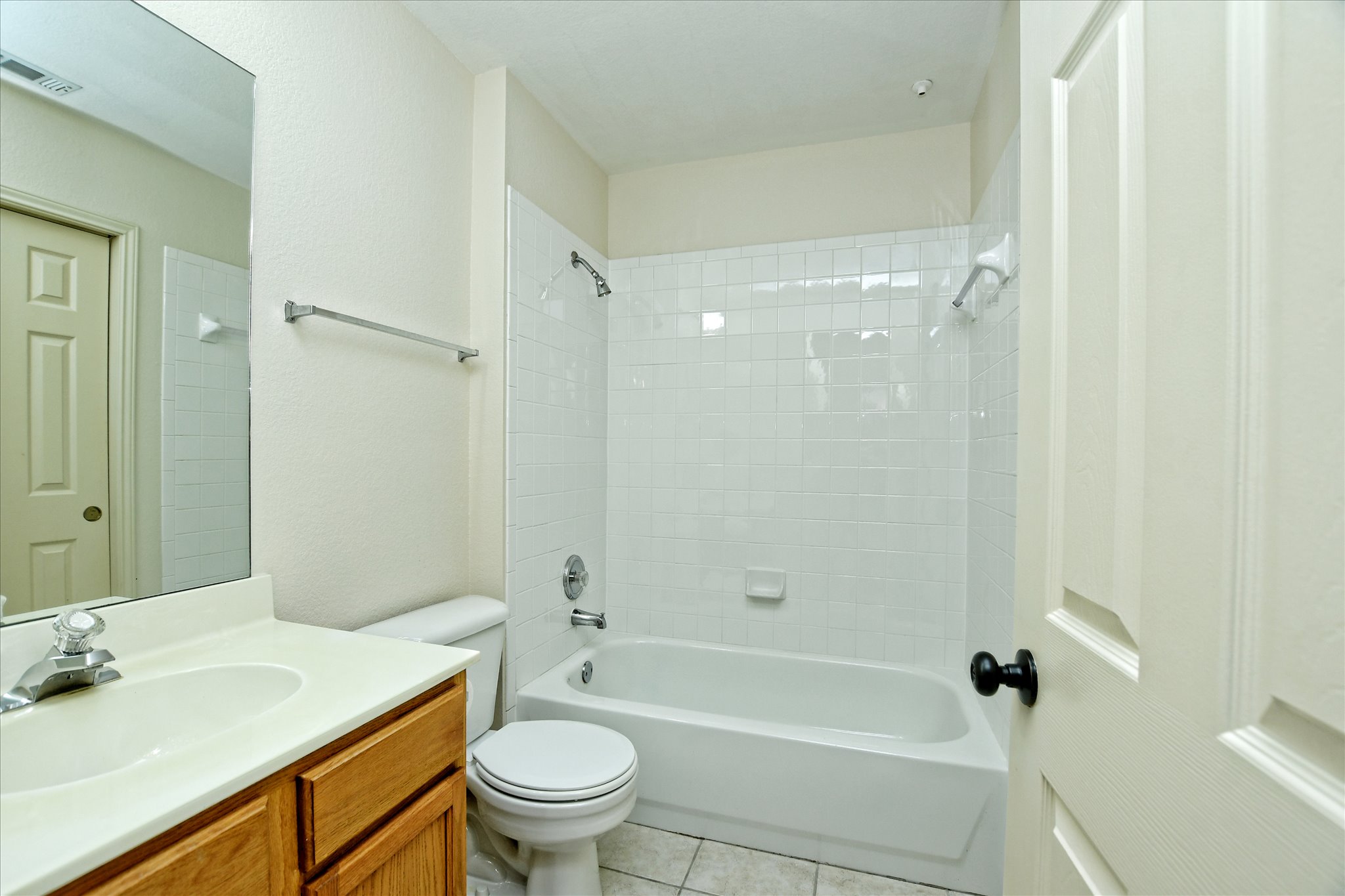 4400 Switch Willo, Unit 9 Austin, TX 78727 - Photo 22 of 30 Full bathroom featuring shower / bathtub combination, light tile patterned floors, and vanity
