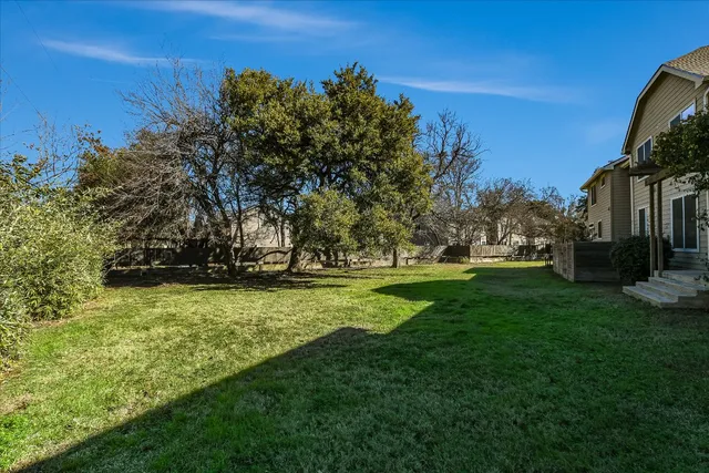 a view of yard with swimming pool and green space