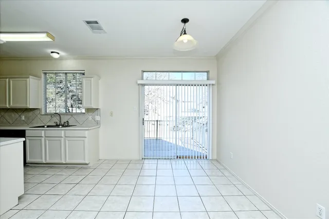 a view of a kitchen with a sink and dishwasher with wooden floor