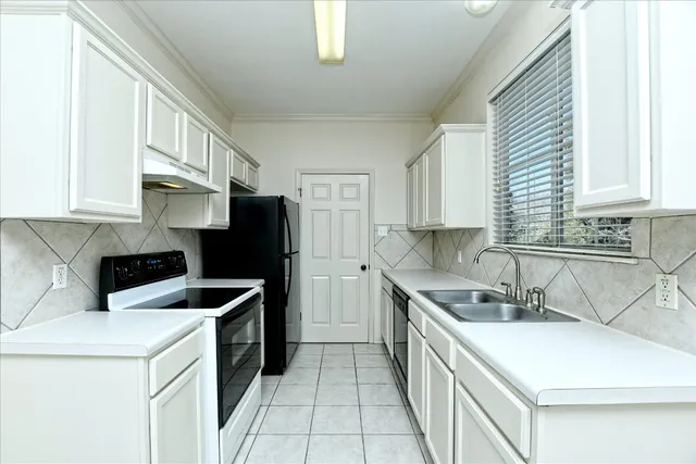 a kitchen that has a sink and a stove