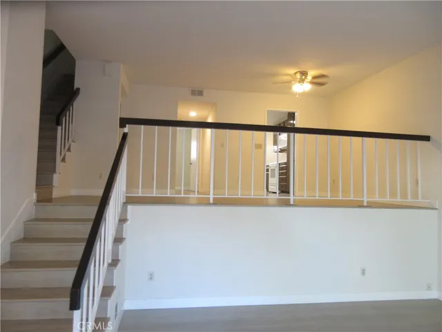 a view of entryway with wooden floor and stairs