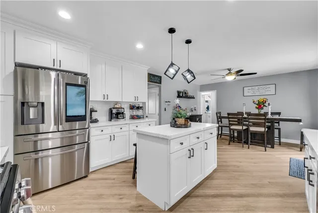 a kitchen with white cabinets and stainless steel appliances