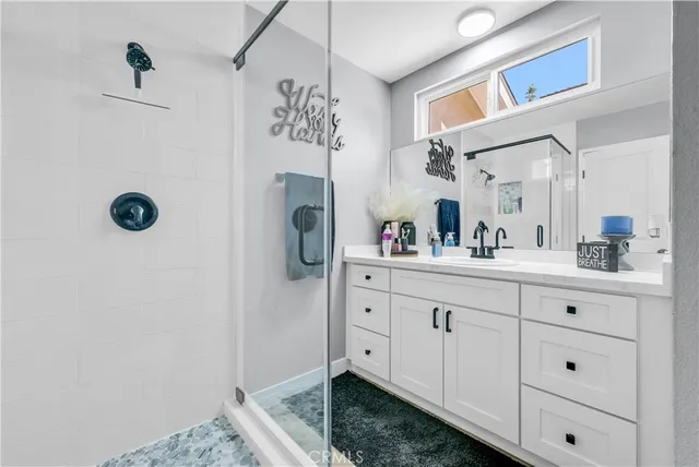 a spacious bathroom with a sink and a mirror
