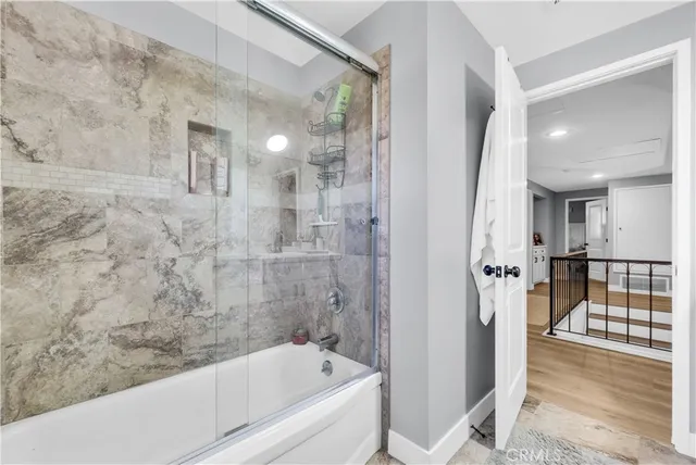 a bathroom with a bathtub and shower