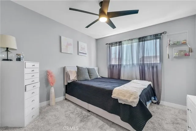 a bedroom with a bed and ceiling fan
