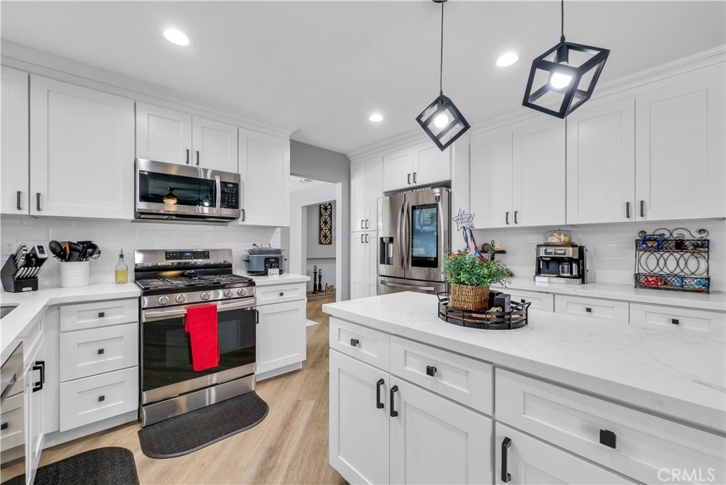 5991 Rogers Lane San Bernardino, CA 92404 - Photo 2 of 33 a kitchen with stainless steel appliances granite countertop a sink a stove and cabinets