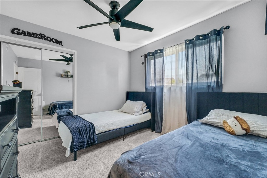 5991 Rogers Lane San Bernardino, CA 92404 - Photo 21 of 33 a bedroom with two beds and ceiling fan