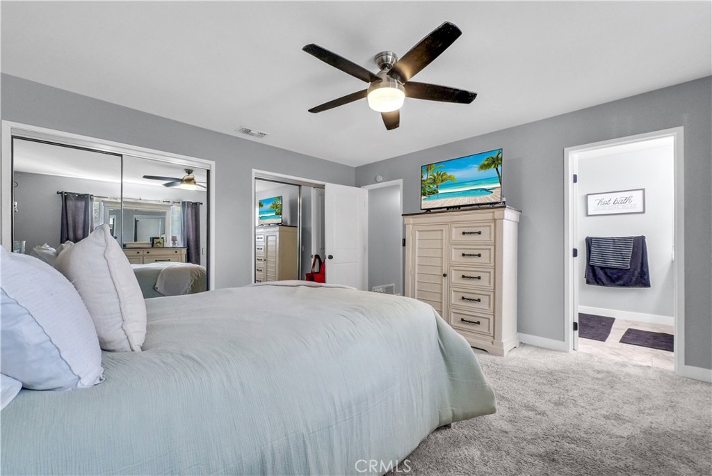 5991 Rogers Lane San Bernardino, CA 92404 - Photo 23 of 33 a bedroom with a bed a dresser and a large mirror