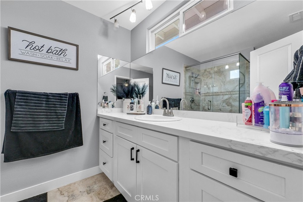 5991 Rogers Lane San Bernardino, CA 92404 - Photo 24 of 33 a bathroom with a sink and a mirror
