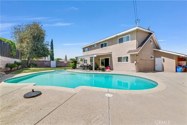 a view of a house with a yard and sitting area