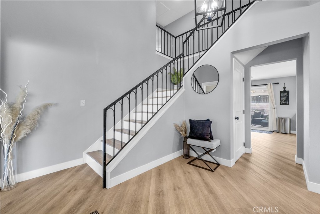 5991 Rogers Lane San Bernardino, CA 92404 - Photo 5 of 33 a view of entryway with wooden floor and stairs