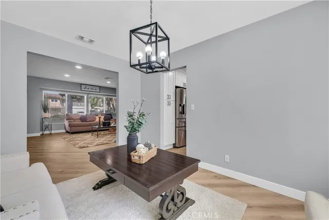 a view of a livingroom and dining room with wooden floor