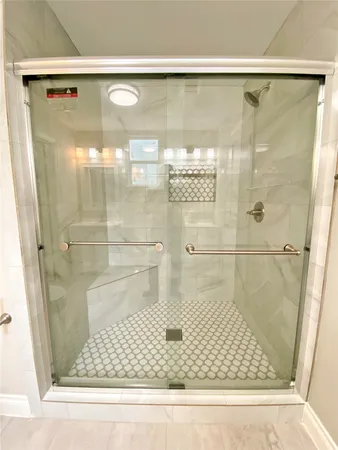 a bathroom with a glass shower door