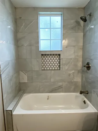 a bathroom with a bathtub and a shower