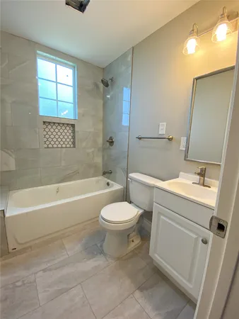 a bathroom with a sink toilet and bathtub