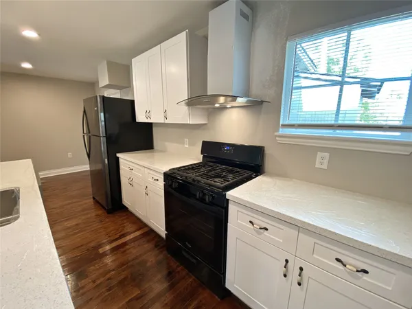 a kitchen with a stove and a refrigerator