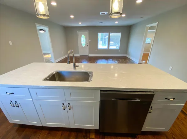 a kitchen with a sink a window and chandelier