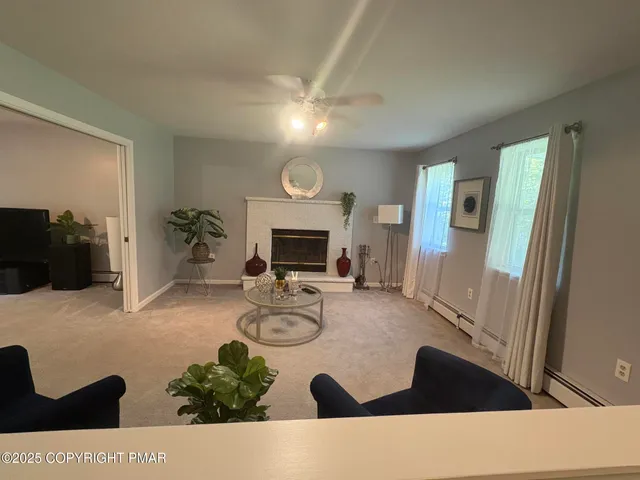 a room with a air conditioner and a ceiling fan