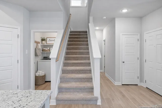 a view of entryway and hall with wooden floor