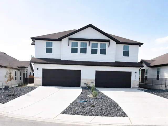 a front view of a house with a garage