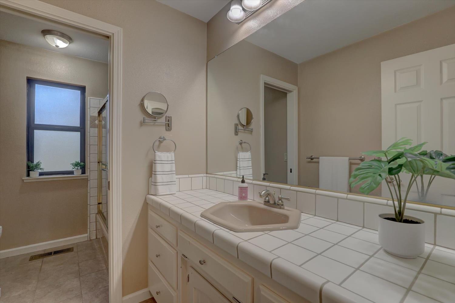 12523 Banner Lava Cap Road Nevada City, CA 95959 - Photo 17 of 57 a bathroom with a sink a toilet and a mirror