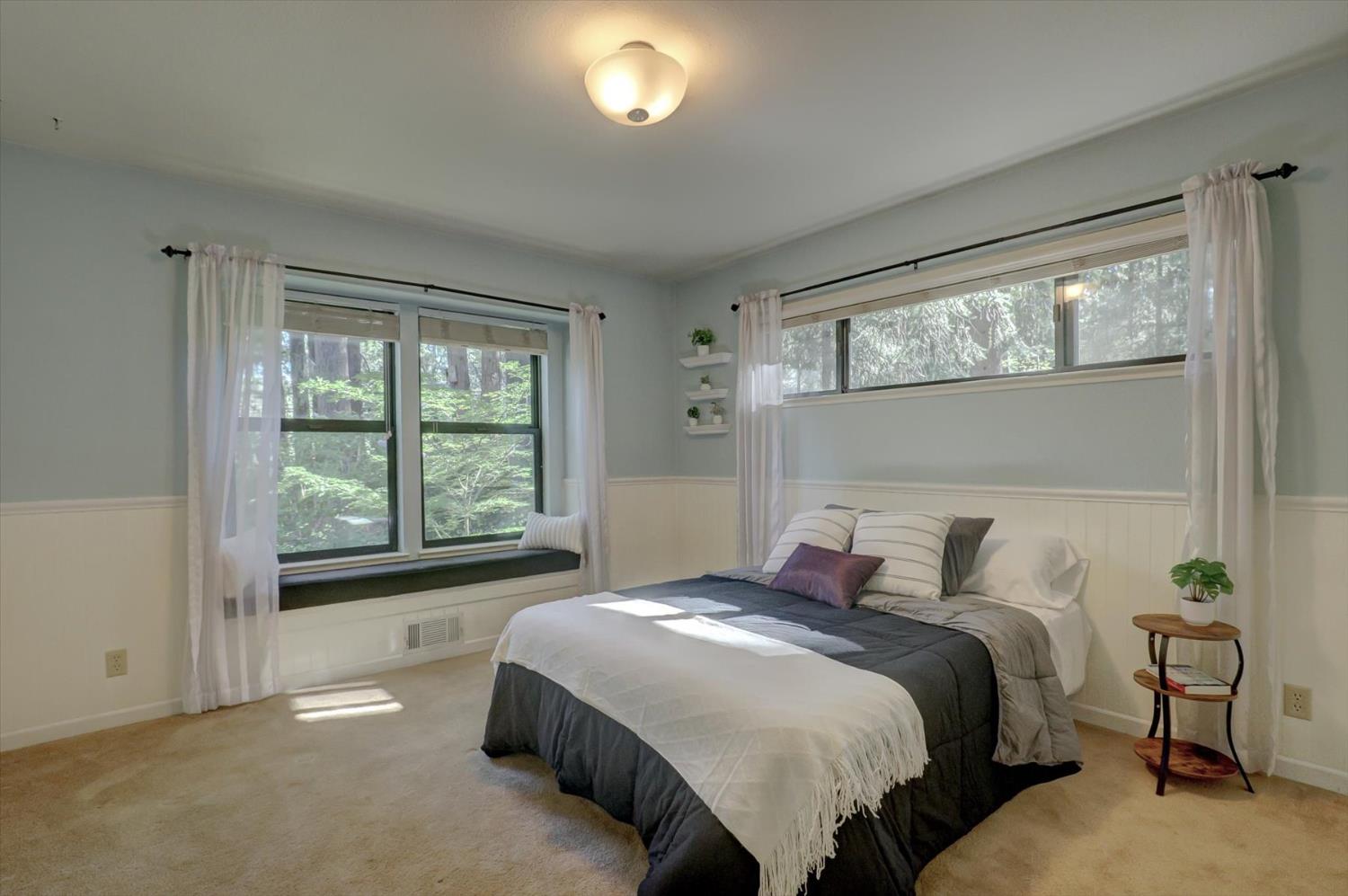 12523 Banner Lava Cap Road Nevada City, CA 95959 - Photo 19 of 57 a bedroom with a bed and a large window