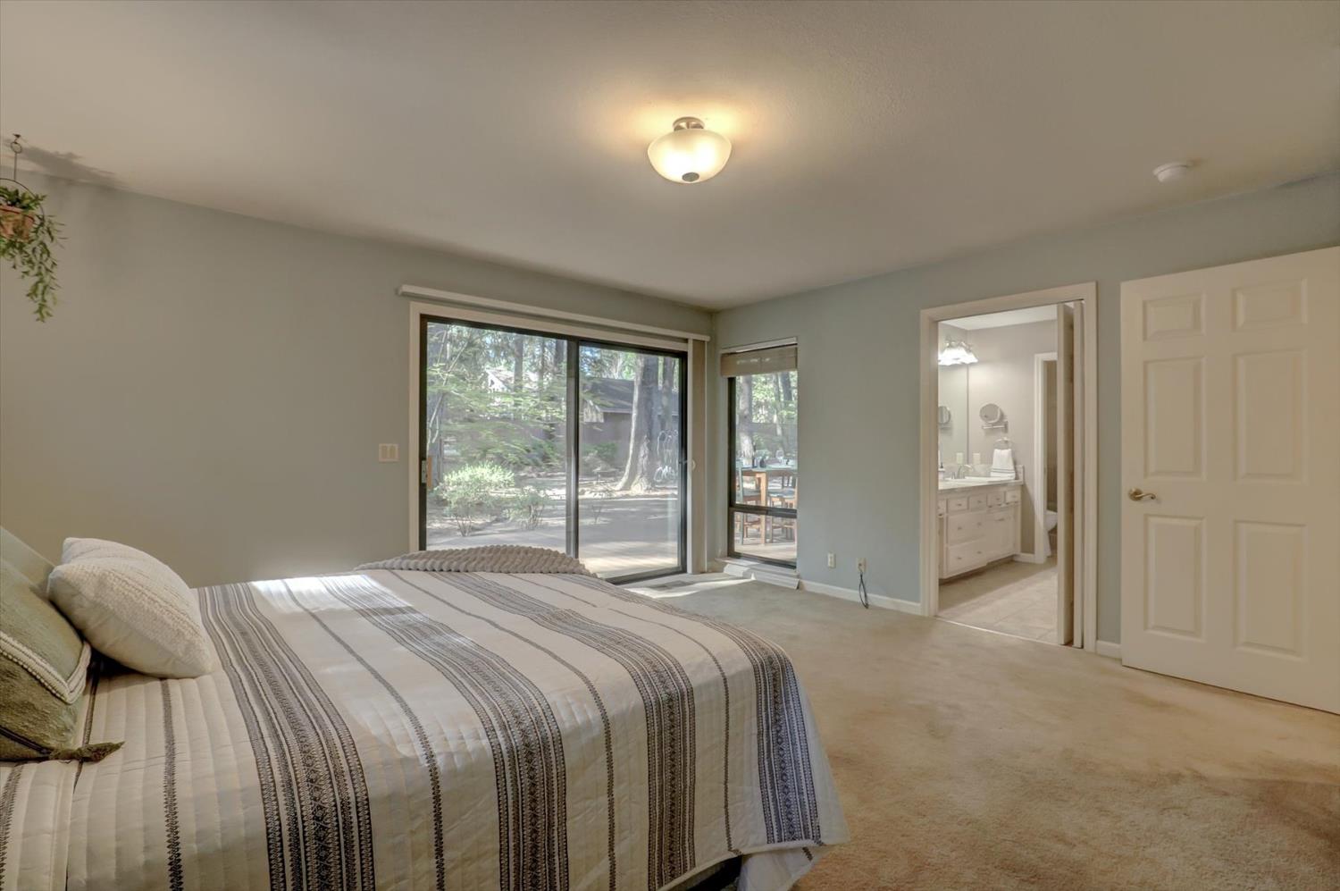 12523 Banner Lava Cap Road Nevada City, CA 95959 - Photo 22 of 57 a bedroom with a bed and a large window