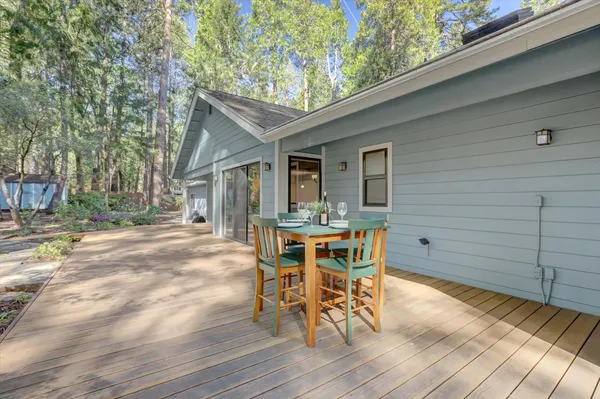 a view of a patio with table and chairs and wooden floor